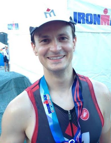 A man wearing a hat and smiling for the camera.