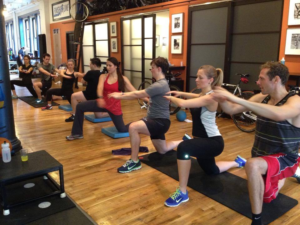 A group of people doing different exercises in the gym.