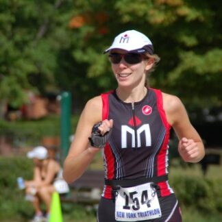 A woman running in the park wearing a hat