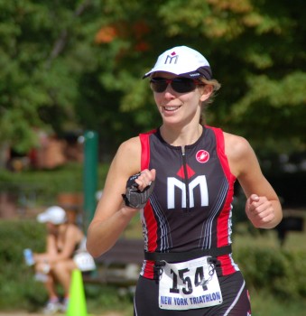 A woman running in the park wearing a hat