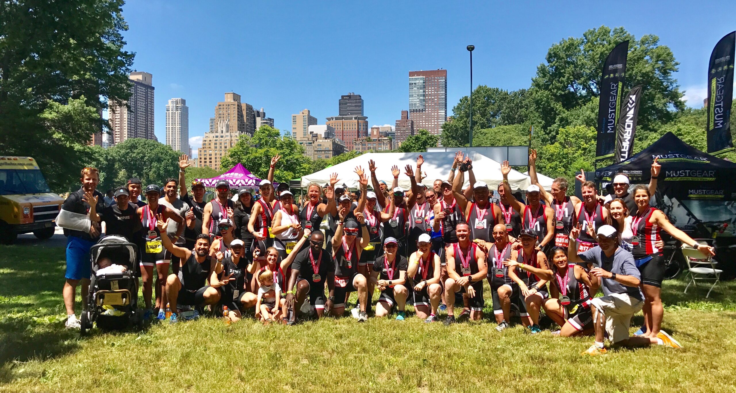 A group of people standing in the grass.