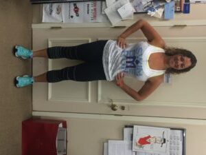 Woman posing in athletic wear indoors.