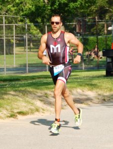 Man running in a triathlon race.