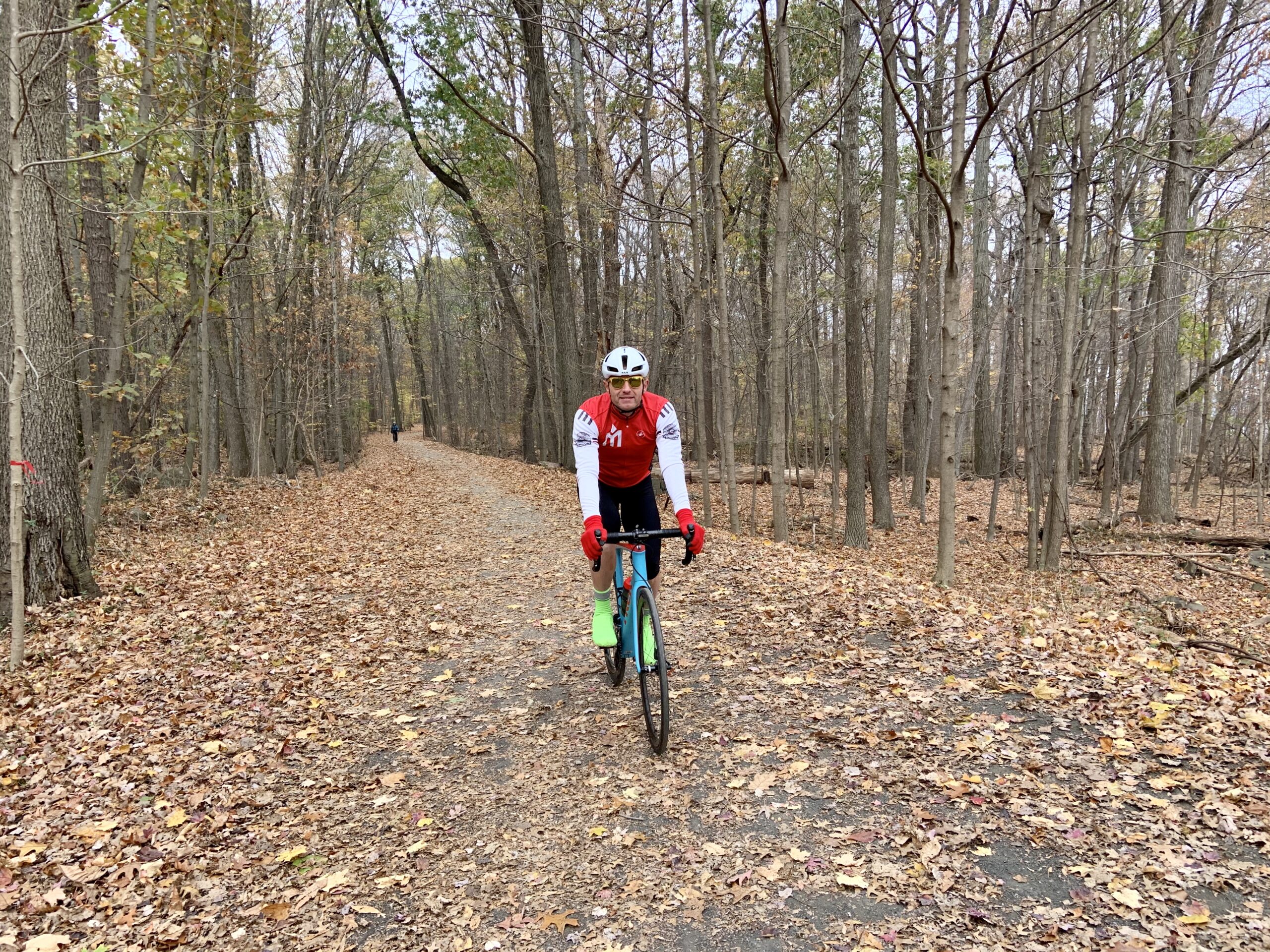A person riding a bike on a trail in the woods.