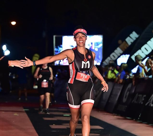 A woman in black and white shorts walking on a street.