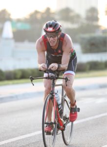 Cyclist racing on a road bike.