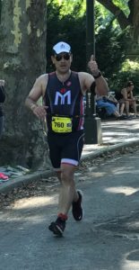 Runner giving thumbs up during race.