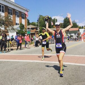 Runner celebrating at marathon finish line.