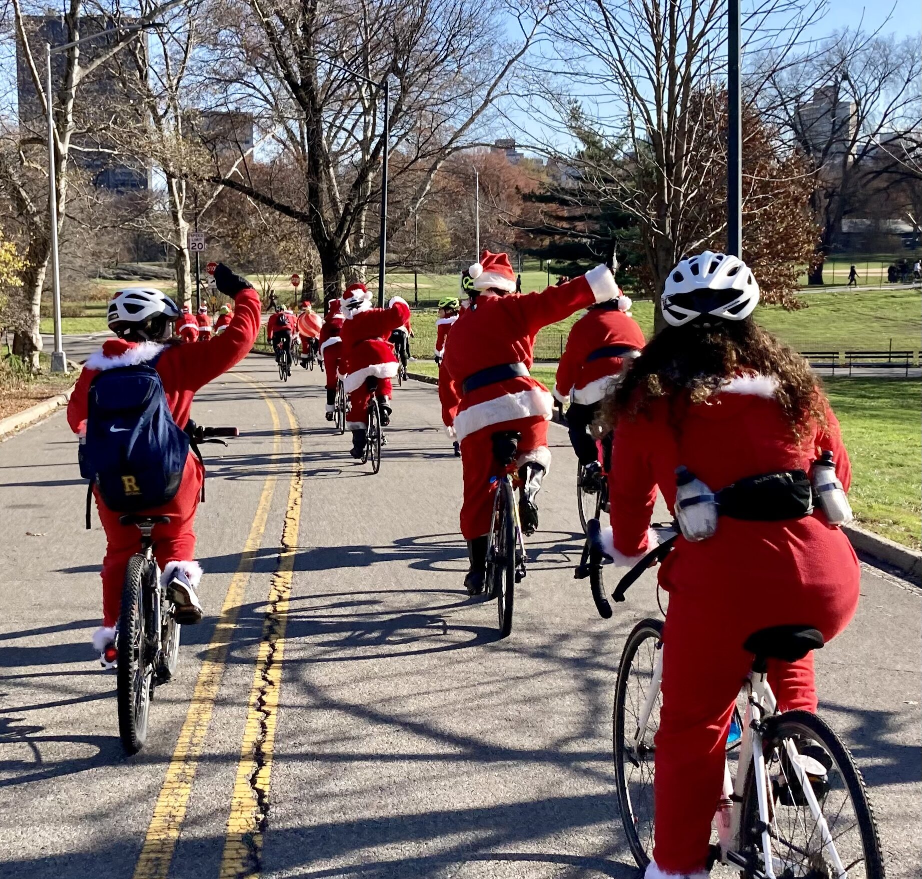 A group of people riding bikes down the street.