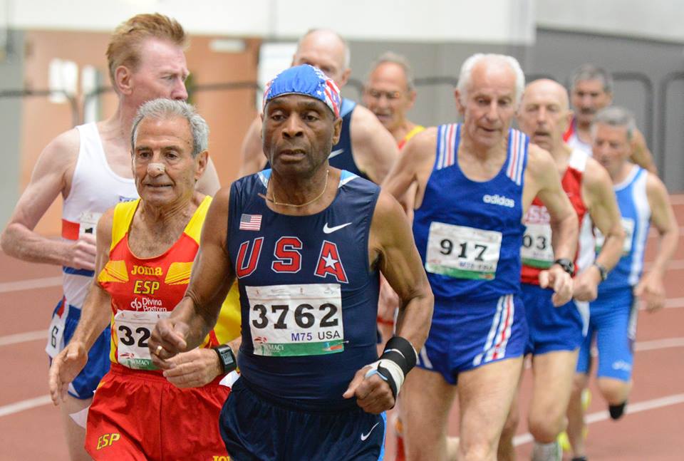 A group of men running in the middle of a race.