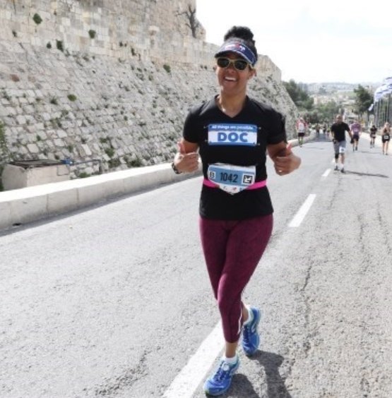A woman running on the side of a road.