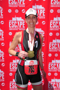 Athlete smiling with medal after race.