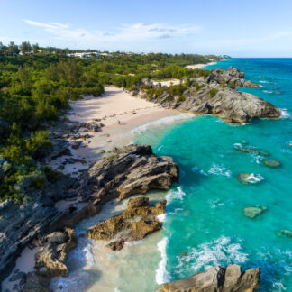 A beach with lots of rocks and water