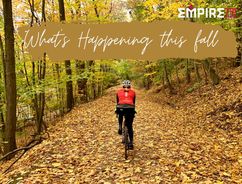 Cyclists on leaf-covered path in autumn.