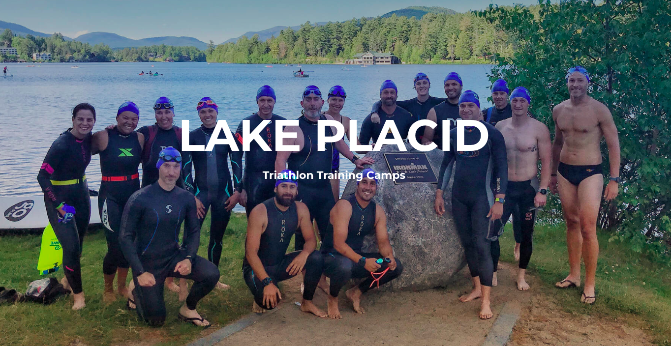 A group of men in wet suits standing next to each other.